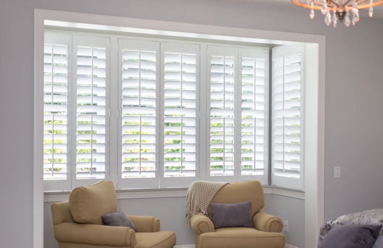 North-South windows have energy efficiency issues rather than sun glare problems. White plantation shutters in sitting area